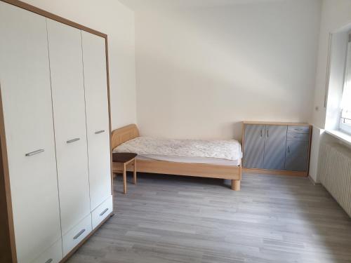 a bedroom with a bed and a dresser at Osterbrock EG Monteurwohnung in Geeste