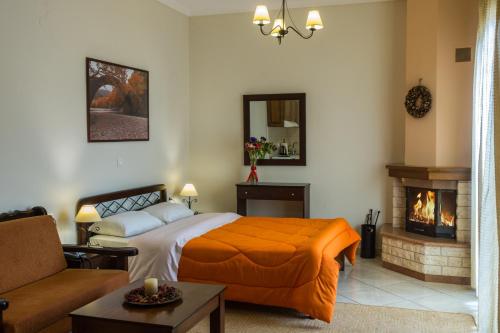 a bedroom with a bed and a fireplace at Chrysandra in Karpenision
