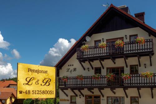 een gebouw met een uithangbord ervoor bij L&B Spa in Karpacz