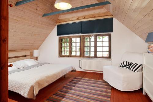 a bedroom with a bed and a chair in a attic at Galerie Napoli in Bystřec