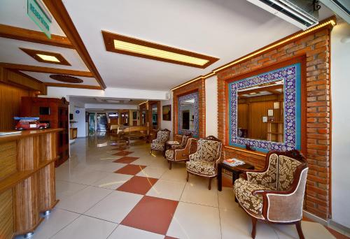 a lobby with chairs and a mirror on a wall at Hotel Azmakhan in Akyaka