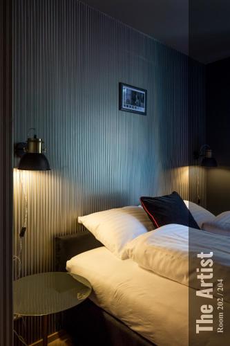 a bedroom with two beds and a table in it at The Henry Self Check-In Guesthouse in Zürich