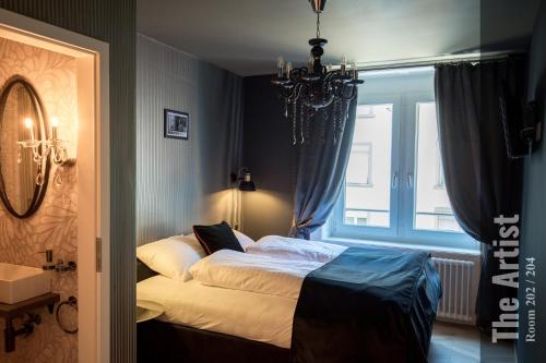 a bedroom with a bed and a window at The Henry Self Check-In Guesthouse in Zürich