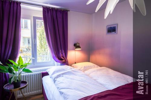 a bedroom with a bed and a window with purple curtains at The Henry Self Check-In Guesthouse in Zürich