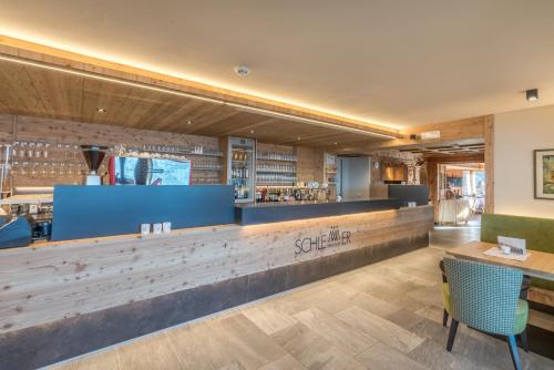 a restaurant with a counter and a bar at Berghotel Schlemmer in Bressanone