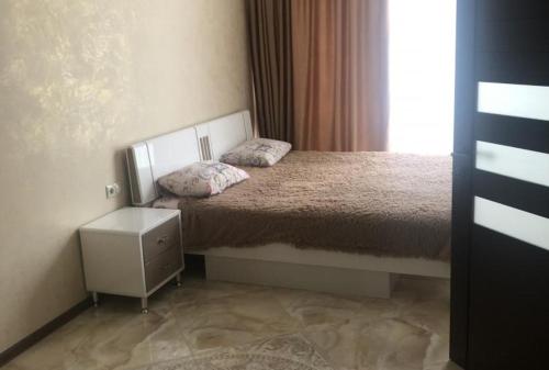 a small bedroom with a bed and a window at LUX in Pizunda