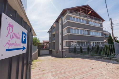 a building with a parking sign in front of it at Rania Apartments in Cluj-Napoca