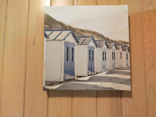 a painting of beach huts on a wall at La dépendance verte in Bordeaux