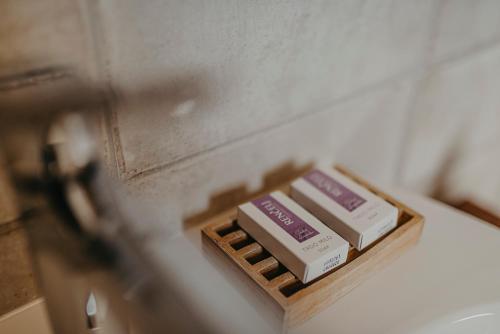a box of soap sitting on top of a sink at Casa Krasna Gourmet Boutique Hotel in Lokev