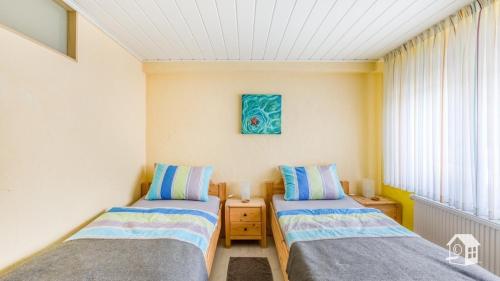 
Ein Bett oder Betten in einem Zimmer der Unterkunft Pension zum Rothaarsteig
