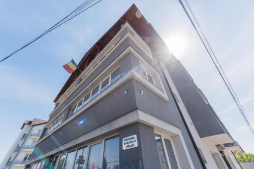 a building with a sign on the side of it at Rania Apartments in Cluj-Napoca