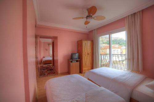 a bedroom with two beds and a window at Nazar Hotel in Selcuk