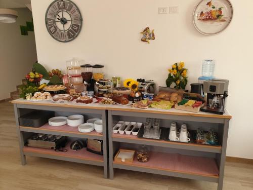 a shelf filled with food and a clock on a wall at B&B Villa Chiara - Bed And Breakfast in Taormina
