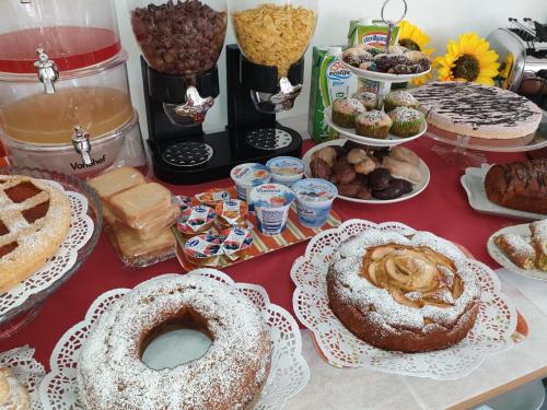 a table topped with lots of different types of desserts at B&B Villa Chiara - Bed And Breakfast in Taormina