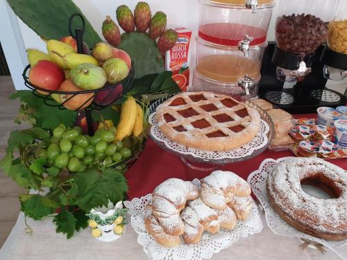 a table with pies and other food on it at B&B Villa Chiara - Bed And Breakfast in Taormina