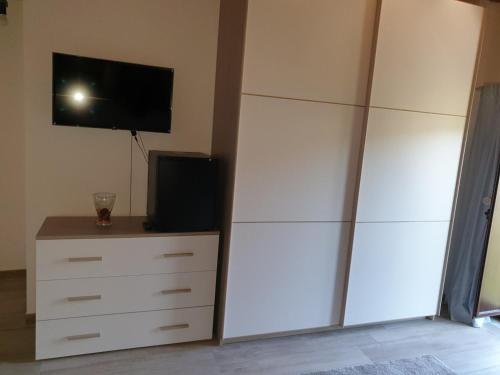 a bedroom with a dresser and a tv on a wall at B&B Villa Chiara - Bed And Breakfast in Taormina