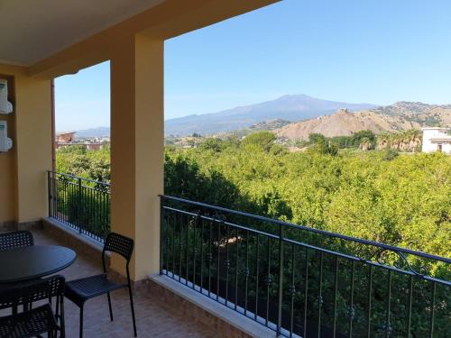 a balcony with a table and chairs and a view at B&B Villa Chiara - Bed And Breakfast in Taormina