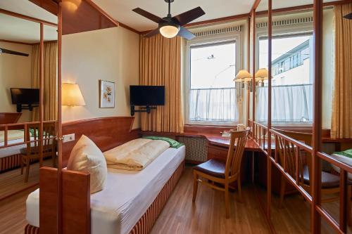 a hotel room with a bed and a window at Hotel Garni Bodensee in Bregenz