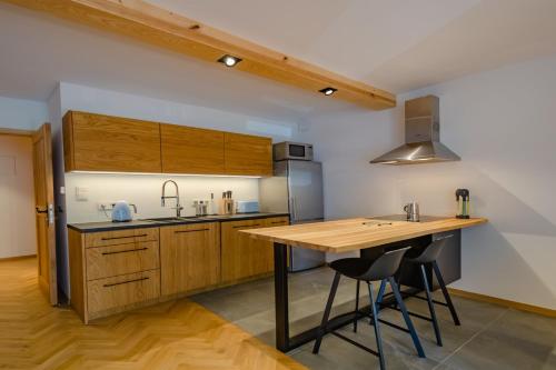 uma cozinha com armários de madeira e uma mesa de madeira em Rent like home - Za Cieszynianką 3 em Zakopane