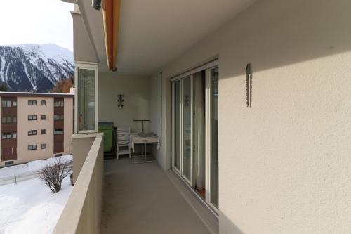a balcony of a building with a view of a mountain at Casa Bünda in Davos