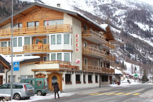 a building on the side of a snow covered mountain at Hotel und Appartments Eden in Saas-Grund