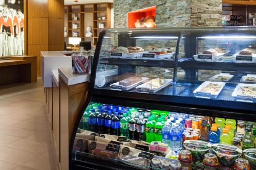 a display case in a store filled with lots of drinks at Hyatt Place Bloomington Indiana in Bloomington