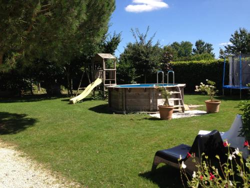a yard with a playground with a slide at Home Paradis & Spa - Ecolodge in Souvigné