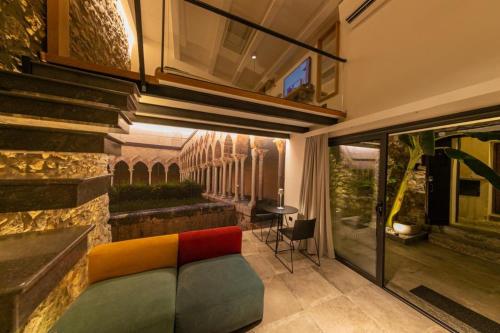 a living room with a couch in a house at MORAMUSA Charme Apartment in Cefalù