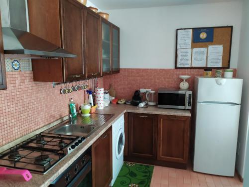 a kitchen with a sink and a white refrigerator at Casa di Debora in Perugia
