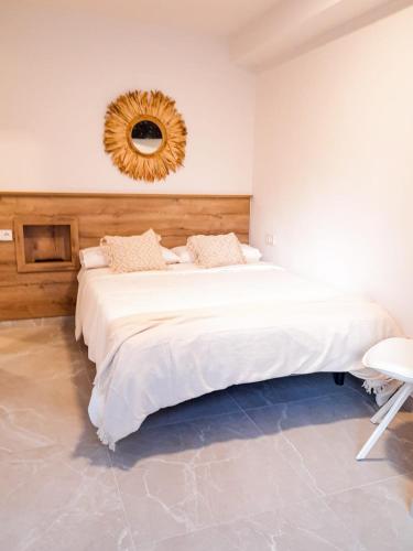 a bedroom with a large bed with a mirror on the wall at Bonefish Apartment in Villajoyosa