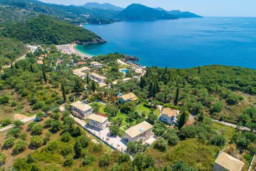 an aerial view of a house on the shore of a lake at Bellou Villas Sivota in Sivota