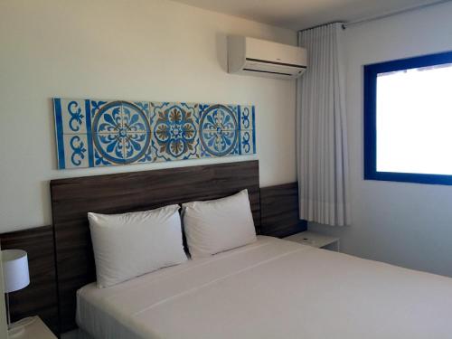 Tempat tidur dalam kamar di Atlântico Hotel Maceió