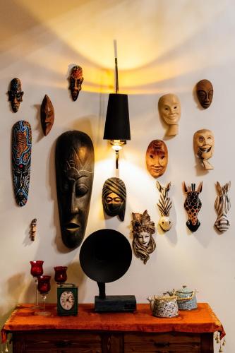 a wall with masks hanging on a wall at Esperanza Boutique Hotel of Lykia in Karaoz