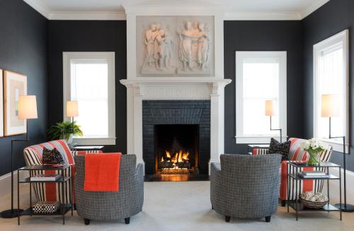 a living room with chairs and a fireplace at Inns of Aurora Resort & Spa in Aurora