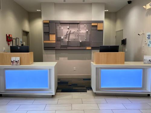 a waiting room with two counters with blue lights at Holiday Inn Express - Eunice by IHG in Eunice