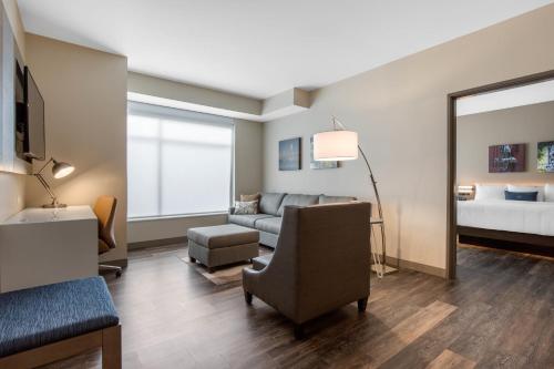 a living room with a couch and a bed at Cambria Hotel Mount Pleasant - Charleston in Charleston