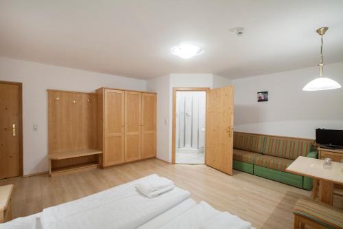 a room with a bed and a couch in it at Hotel Kammerhof in Mariastein
