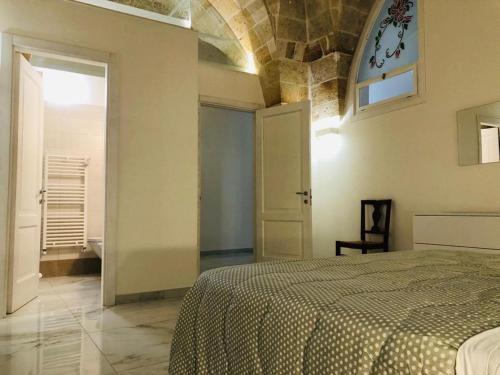 a bedroom with a bed and an open door at AL VECCHIO FRANTOIO in Manduria