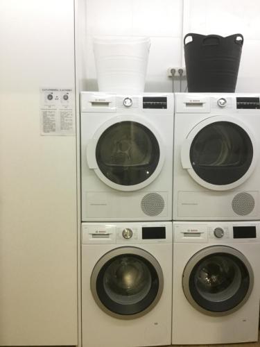 two washing machines and a washer and dryer at A Conserveira in Redondela