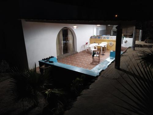 a view of a house with a table and chairs at Scialu & Riscialu in Pantelleria