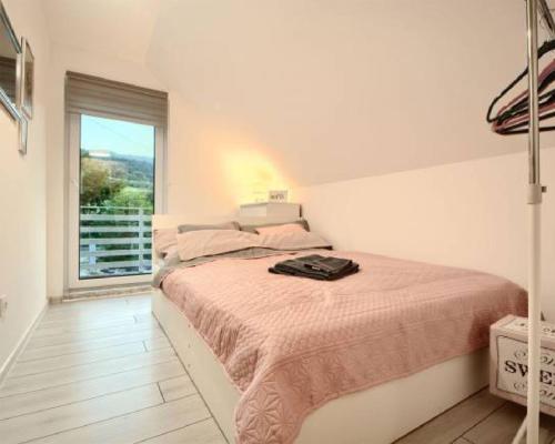 a bedroom with a bed and a large window at Bliźniakówka in Brenna