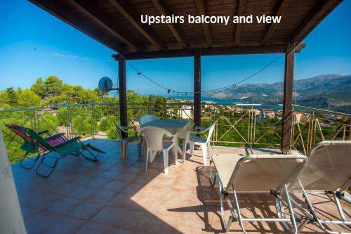 a balcony with a table and chairs and a view at Helmata Villa with privecy in Argostoli