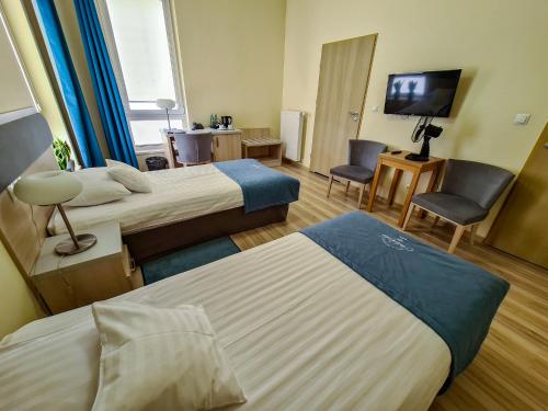 Postel nebo postele na pokoji v ubytování Antonińska Hotel & Apartamenty