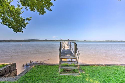 a ladder leading into a body of water at Lakefront Retreat with Pier, Bar Hut and Fireplace! in Graford
