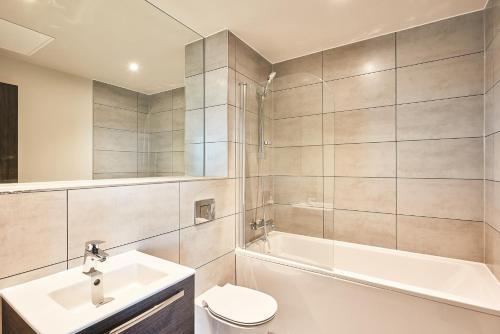 a bathroom with a sink and a toilet and a tub at Seven Living Bracknell - Serviced Apartments in City Centre - Free Parking in Bracknell