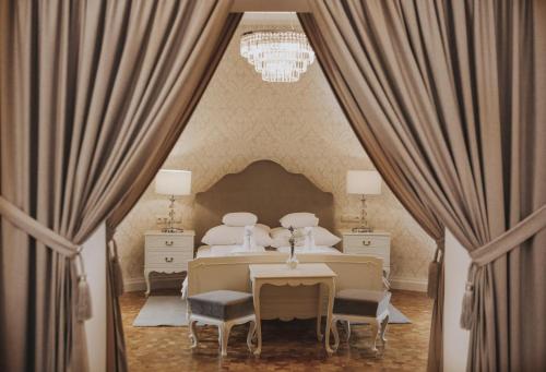 um quarto com uma cama, uma mesa e cadeiras em Hotel Zamek Chałupki em Ruderswald