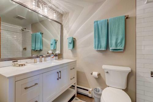 a bathroom with a toilet and a sink and a mirror at Mountain-View Vail Condo with Balcony and Gas Grill! in Vail