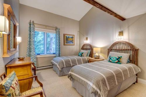 a bedroom with two beds and a window at Mountain-View Vail Condo with Balcony and Gas Grill! in Vail