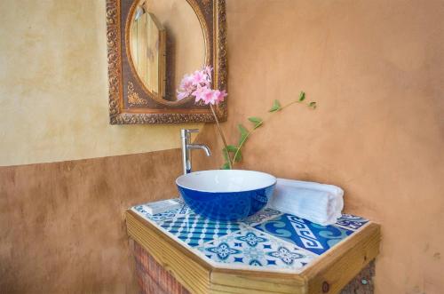 a bathroom with a sink and a mirror at Caliu Earthship Ecolodge in Colonia del Sacramento