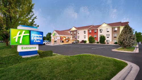 a building with a sign in a parking lot at Holiday Inn Express & Suites Sandy - South Salt Lake City by IHG in Sandy